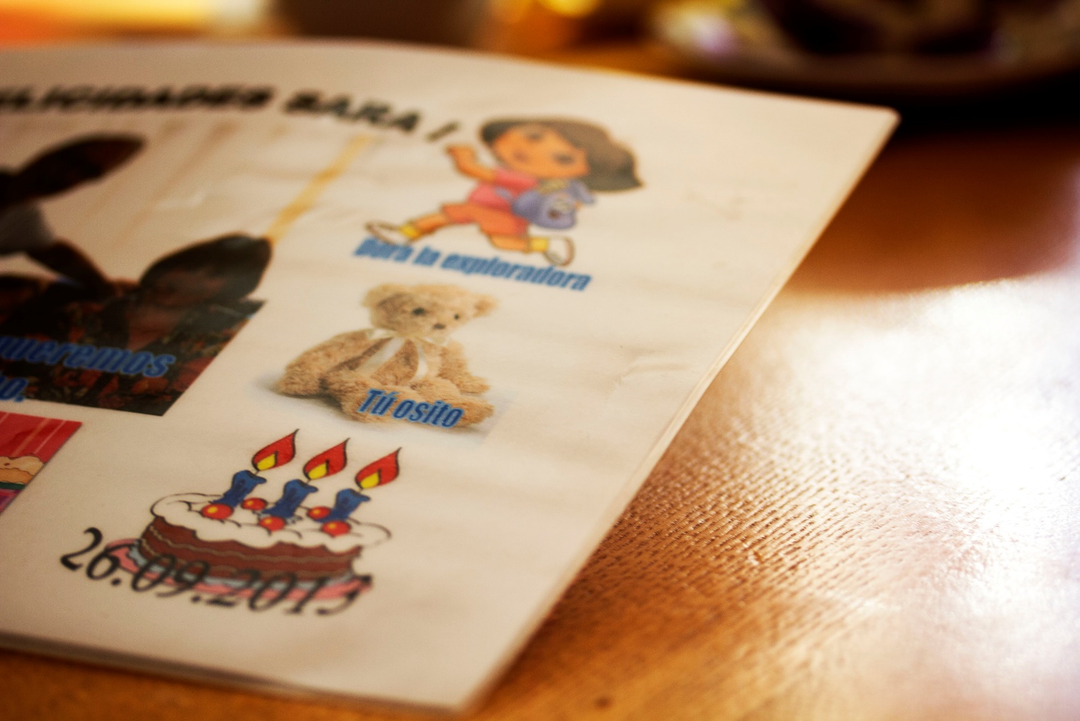 Figure 1: This handmade “poster” combines the flexibility of digital manipulation with the robustness of printed photographs. Being laminated speaks to durability and to Pedro’s and Maria’s fondness of hanging images around the house. The central image depicts the grandparents together with the grandchild during one of their visits, which manifests the networked character of this seemingly analogue print.